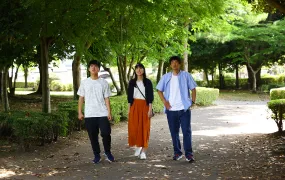 Picture of three young people walking in a park